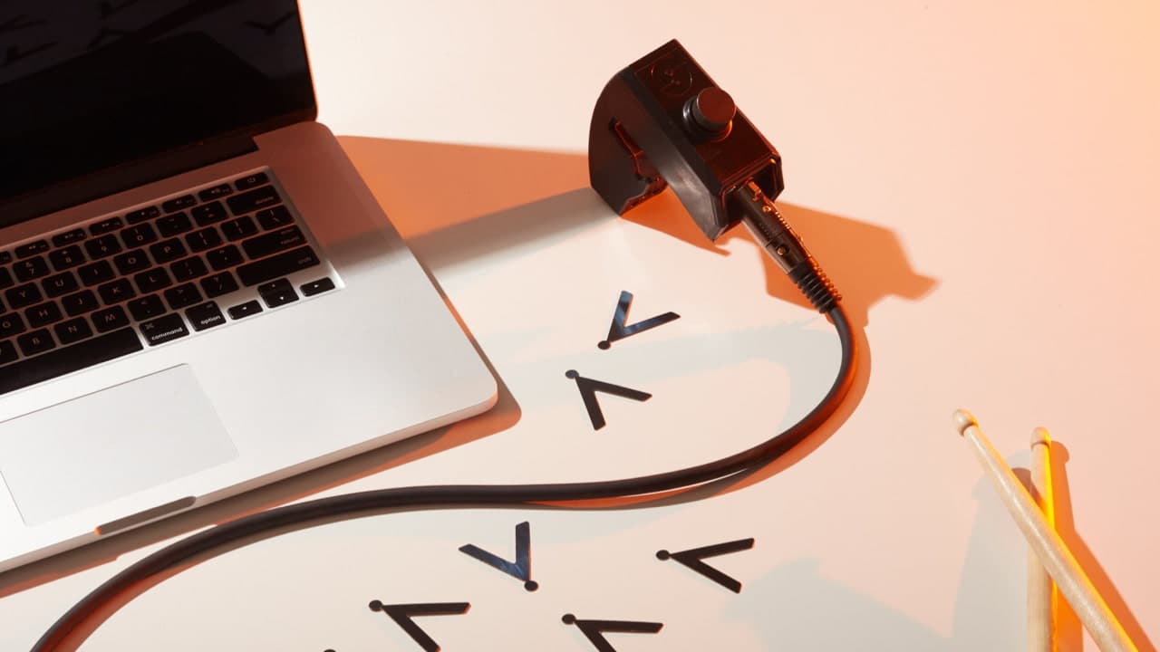 A photo of a laptop with a sensor on a table